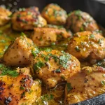 A delicious Garlic Butter Chicken Skillet with melted butter and garlic, garnished with herbs.
