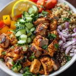 A delicious Chicken Shawarma Bowl showcasing tender chicken and fresh produce from a side angle.