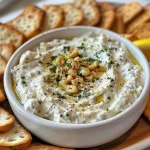 Appetizer featuring garlic and herb cheese with a sprinkle of chili flakes and lemon zest.
