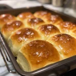 A set of warm, pillowy dinner rolls arranged neatly, showcasing their delicious texture.