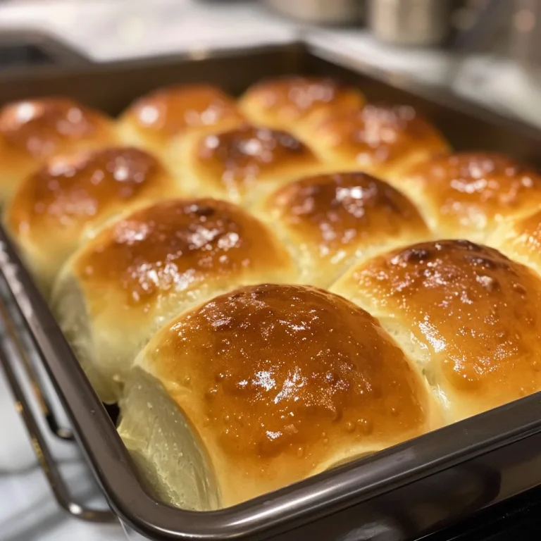 A set of warm, pillowy dinner rolls arranged neatly, showcasing their delicious texture.