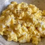 Juicy scrambled egg mix displayed in a shallow dish.