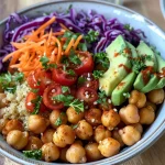 A nutritious plant-based bowl with chickpeas, diced cucumber, cherry tomatoes, and a sprinkle of parsley.