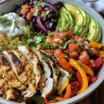 Juicy Chicken Fajita Burrito Bowl with layers of cilantro lime rice, sliced onions, and optional toppings.