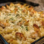 Delicious creamy chicken Alfredo pasta bake served in a dish.