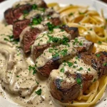 Close-up of creamy Cajun steak pasta with vibrant peppers and melted cheese.