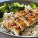 Close-up of meal prep container featuring chicken, rice, and broccoli.