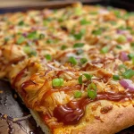 Juicy BBQ Chicken Pizza featuring a crispy crust and colorful garnishes.