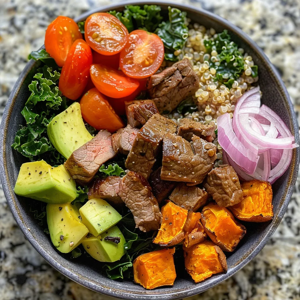 Juicy beef protein bowl with quinoa and vibrant vegetables in a side view.