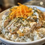 Image of tender chicken pieces garnished with ranch seasoning and mixed with fluffy rice.