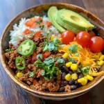 A close-up side view of a Ground Beef Taco Rice Bowl with vibrant toppings.