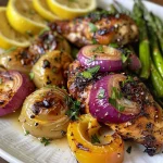 Close-up view of juicy Lemon Garlic Chicken garnished with fresh parsley and lemon slices.