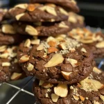 Close-up of a delicious Double Chocolate Almond Cookie with a textured surface and visible almond pieces.