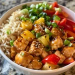Close-up of a Hawaiian Chicken Bowl with colorful ingredients arranged attractively.