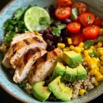 Close-up of a colorful quinoa power bowl featuring grilled chicken and fresh vegetables.