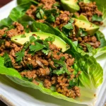 Close-up of juicy beef lettuce wraps filled with avocado and yogurt.