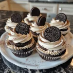 Close-up of layered No-Bake Oreo Cheesecake Cups with crushed Oreos on top.