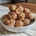 Close-up view of No-Bake Peanut Butter Energy Bites with oats and chocolate chips.