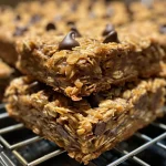 Close-up of oatmeal chocolate chip bars showcasing a golden-brown crust and chocolate chips.