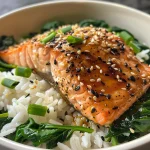 Close-up view of a salmon and spinach rice bowl, showcasing vibrant colors and textures.