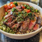 Close-up of a juicy steak quinoa bowl featuring vibrant vegetables and garnishes.