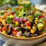 A colorful Zesty Black Bean and Corn Salad in a bowl with vibrant ingredients.
