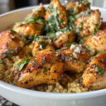 Juicy Lemon Parmesan Chicken served atop a bed of fluffy couscous.