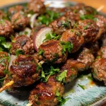 ['Juicy Air Fryer Kofta Kebabs arranged on a plate, showcasing their savory spices.', 'Close-up side view of grilled Air Fryer Kofta Kebabs, highlighting their juicy texture.', 'A platter of Air Fryer Kofta Kebabs garnished with parsley, emphasizing their deliciousness.', 'Side view of Air Fryer Kofta Kebabs on a wooden board, revealing their rich color and spices.']