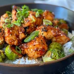 ['Close-up view of juicy Air Fryer Sweet Chili Chicken with Brussels sprouts.', 'Side view of cooked Sweet Chili Chicken and Brussels sprouts, vibrant colors and textures.', 'Delicious chicken pieces glazed in sweet chili sauce with halved Brussels sprouts.', 'A dish featuring Air Fryer Sweet Chili Chicken surrounded by roasted Brussels sprouts.']