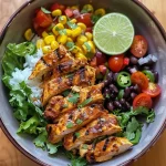 ['Juicy Chicken Burrito Protein Bowl featuring colorful ingredients.', 'Close-up view of a Chicken Burrito Protein Bowl with chicken, rice, and vegetables.', 'Side view of a delicious Chicken Burrito Protein Bowl filled with fresh toppings.', 'Vibrant Chicken Burrito Protein Bowl showcasing layers of rice, chicken, and veggies.']