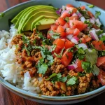 ['Close-up view of a vibrant Easy Peasy Turkey Bowl featuring ground turkey, rice, and avocado.', 'Side view of a delicious Easy Peasy Turkey Bowl topped with fresh pico salad ingredients.', 'Juicy Easy Peasy Turkey Bowl showcasing layers of turkey, jasmine rice, and diced avocado.', 'Colorful close-up of Easy Peasy Turkey Bowl made with ground turkey and fresh vegetables.']