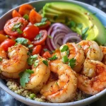 ['A close-up view of a quinoa bowl topped with shrimp, avocado, and cherry tomatoes.', 'A vibrant quinoa bowl featuring shrimp and fresh vegetables, seen from the side.', 'A detailed side view of a shrimp quinoa bowl with colorful ingredients visible.', 'A close-up of a healthy quinoa bowl showcasing succulent shrimp and diced avocado.']