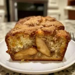 ['Close-up of a slice of Apple Cider Cinnamon Bread, showcasing its moist texture and cinnamon sugar topping.', 'Side view of freshly baked Apple Cider Cinnamon Bread with a golden-brown crust and warm spices.', 'A beautifully baked loaf of Apple Cider Cinnamon Bread, highlighting the ingredients and inviting aroma.', 'Slices of homemade Apple Cider Cinnamon Bread served on a wooden board, with a sprinkle of cinnamon sugar.']