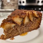 ['Close-up view of a caramel pear upside-down gingerbread cake, showcasing juicy pear slices on top.', 'Side view of a moist gingerbread cake with caramelized pears, emphasizing its rich texture.', 'Delicious caramel pear gingerbread cake with a glossy caramel layer and sliced pears on top.', 'Tantalizing side shot of an upside-down gingerbread cake, drizzled with caramel and adorned with pear slices.']