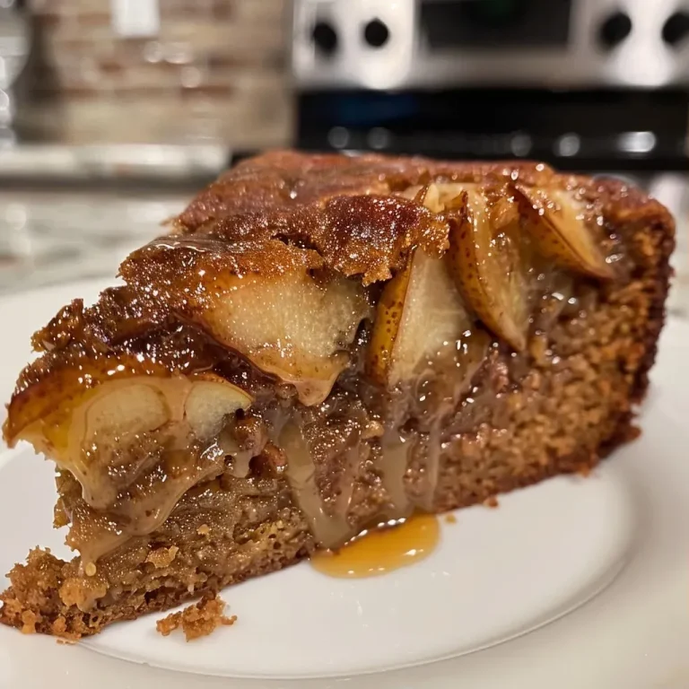 ['Close-up view of a caramel pear upside-down gingerbread cake, showcasing juicy pear slices on top.', 'Side view of a moist gingerbread cake with caramelized pears, emphasizing its rich texture.', 'Delicious caramel pear gingerbread cake with a glossy caramel layer and sliced pears on top.', 'Tantalizing side shot of an upside-down gingerbread cake, drizzled with caramel and adorned with pear slices.']