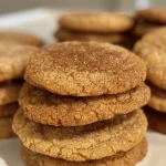 ['Close-up view of golden-brown Chai Sugar Cookies with a sprinkle of powdered sugar.', 'Side view of freshly baked Chai Sugar Cookies with a rich, spiced texture.', 'A delectable arrangement of Chai Sugar Cookies, showcasing their inviting, soft edges.', 'Delicious Chai Sugar Cookies stacked on a plate, highlighting their warm color and spices.']