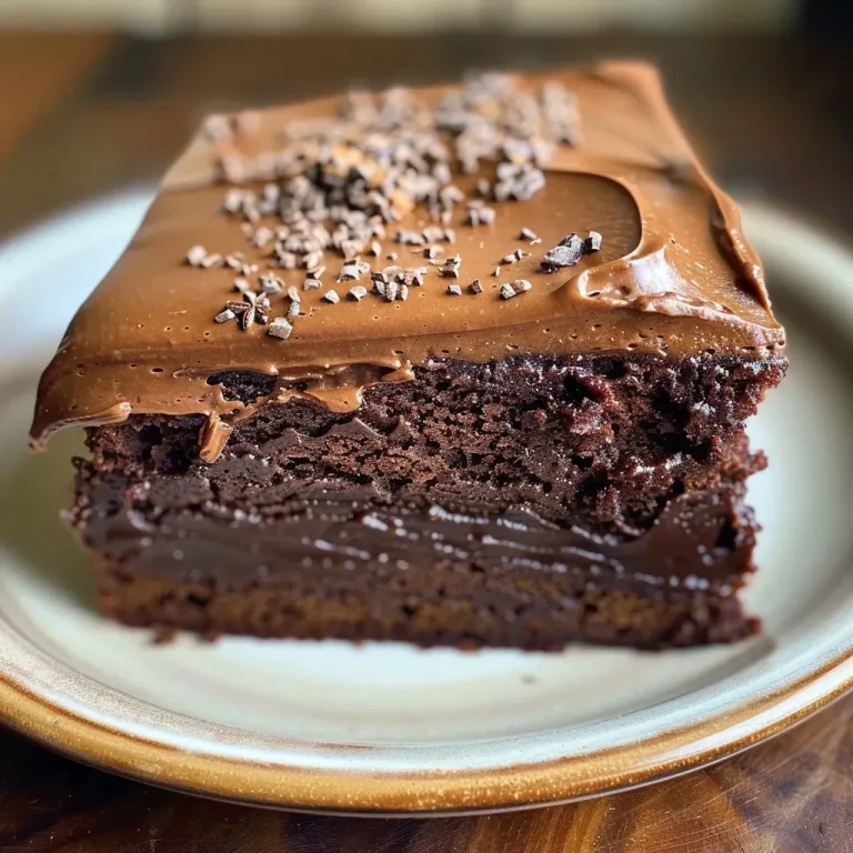 ['Close-up of a moist Chocolate Chai Snack Cake with layers showing.', 'Side view of a rich Chocolate Chai Snack Cake with creamy frosting on top.', 'Luscious slice of Chocolate Chai Snack Cake displaying a spiced frosting.', 'Detailed shot of a decadent Chocolate Chai Snack Cake showcasing its texture.']