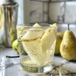 ['Close-up view of a refreshing Pear and Vanilla Spritzer in a clear glass.', 'Side view of a sparkling drink featuring pear slices and a vanilla bean.', 'Refreshing beverage with chilled seltzer, showcasing Bosc pears and vanilla.', 'Detail shot of a fruity spritzer with pear and vanilla, garnished elegantly.']