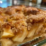 ['A close-up side view of a freshly baked Pinwheel Apple Cobbler.', 'Juicy slices of Pinwheel Apple Cobbler with a golden crust on a plate.', 'A deliciously arranged Pinwheel Apple Cobbler showcasing apple filling.', 'Side view of a warm Pinwheel Apple Cobbler with cinnamon dusting.']