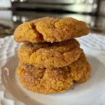 ['Close-up view of Pumpkin Protein Snickerdoodle Cookies, showcasing their golden-brown texture.', 'Side view of freshly baked Pumpkin Protein Snickerdoodle Cookies with a sprinkle of cinnamon.', 'Detailed image of soft Pumpkin Protein Snickerdoodle Cookies with a rich pumpkin color and a dusting of spices.', 'Artisan presentation of Pumpkin Protein Snickerdoodle Cookies, highlighting their chewy texture and warm spices.']