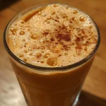 ['Close-up of a Pumpkin Spice Cold Brew in a glass, showcasing its creamy texture and pumpkin spice topping.', 'Side view of a Pumpkin Spice Cold Brew, highlighting layers of coffee and milk with pumpkin puree visible.', 'Detailed shot of a Pumpkin Spice Cold Brew, featuring spices sprinkled on top and a glass filled with a rich, frothy drink.', 'Vibrant image of a Pumpkin Spice Cold Brew served in a clear glass, garnished with cinnamon and creamy layers.']