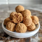 ['Close-up view of a Pumpkin Spice Latte Protein Truffle, showcasing its creamy texture and vibrant color.', 'Side angle photo of a delicious Pumpkin Spice Latte Protein Truffle, highlighting its soft exterior.', 'Detailed shot of a no-bake Pumpkin Spice Latte Protein Truffle, with visible spices and chocolate chips.', 'Close proximity image of a Pumpkin Spice Latte Protein Truffle, emphasizing its rich, inviting appearance.']