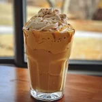 ['A creamy pumpkin spice milkshake with whipped cream and a sprinkle of cinnamon in a glass.', 'Side view of a pumpkin spice milkshake topped with fluffy whipped cream and a dusting of cinnamon.', 'Close-up of a delicious autumn-inspired pumpkin spice milkshake served in a tall glass.', 'Rich pumpkin milkshake with ice cream and spices, topped with whipped cream and cinnamon.']