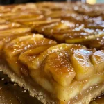 ['Close-up view of Salted Caramel Apple Pie Bars with a golden crust and caramel drizzles.', 'Side view of freshly baked Salted Caramel Apple Pie Bars, showing apple slices and caramel topping.', 'Delicious Salted Caramel Apple Pie Bars stacked on a white plate, highlighting the gooey caramel.', 'A slice of Salted Caramel Apple Pie Bars with visible apple filling and a sprinkle of sea salt on top.']