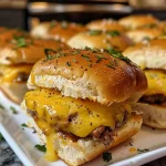 ['Close-up of Sausage Egg and Cheese Breakfast Sliders on a wooden board.', 'Juicy breakfast sliders stacked with sausage, egg, and cheese oozing out.', 'Side view of mouthwatering sausage, egg, and cheese sliders with melted cheese.', 'Deliciously prepared breakfast sliders showcasing layers of sausage, egg, and cheese.']