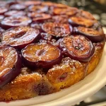 ['A close-up view of a spiced plum upside-down cake showcasing juicy plums on top.', 'Side view of a freshly baked spiced plum upside-down cake with a glossy caramelized surface.', 'A vibrant slice of spiced plum upside-down cake highlighting plums and a soft, buttery texture.', 'Delicious spiced plum upside-down cake with rich colors and a moist appearance.']