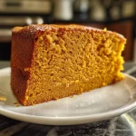 ['Close-up side view of a moist classic pumpkin cake with a rich orange color.', 'Detailed view of a freshly baked pumpkin cake, showcasing its texture and frosting.', 'Side perspective of a delectable pumpkin cake, highlighting its layers and ingredients.', 'Juicy classic pumpkin cake with a smooth frosting, presented from a close-up angle.']