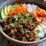 ['Close-up of a Korean beef rice bowl with vibrant vegetables and glossy sauce.', 'Side view of a delicious Korean beef rice bowl filled with minced beef and garnished with green onions.', 'Juicy Korean beef rice bowl featuring sliced cucumbers and kimchi.', 'Detailed view of Korean beef rice bowl with sesame seeds and julienned carrots.']