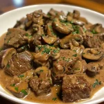 Close-up view of a plate of Healthy Beef Stroganoff with mushrooms and parsley.