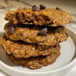 Close-up view of a healthy flourless pumpkin chocolate chip oatmeal protein cookie on a plate.